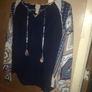 Navy blue blouse with patterned sleeves.